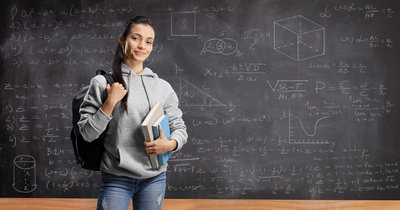 Student in front of blackboard